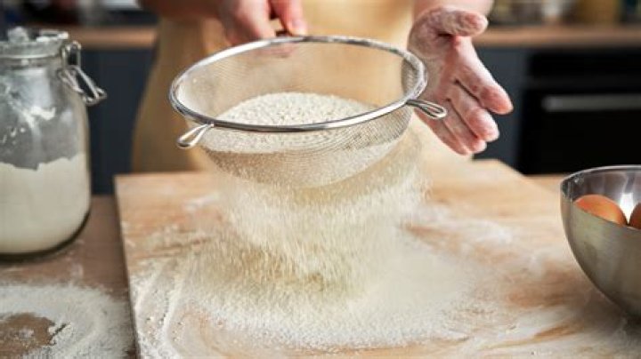How do you remove dried flour from sifters?